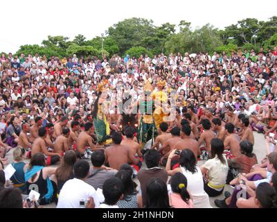 Uluwatu, Indonesia - December 27, 2008: The spectators and performers are participating in traditional religious dance Kecak at Uluwatu, Indonesia on Stock Photo