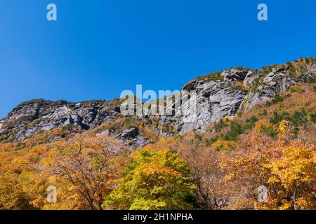mountain peaks and vibrant foliage of woodlands at smugglers notch in vermont Stock Photo