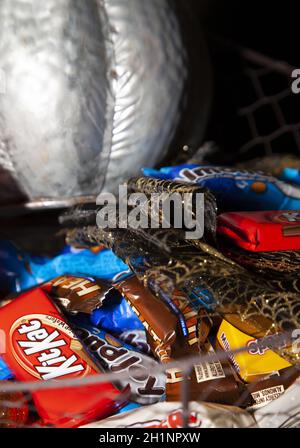 LOUISIANA/USA – OCTOBER 31 2019: Silver pumpkin, orange pumpkin, small sequined pumpkins, black and gold mesh decoration, with Reese's, Heath Bars, Mi Stock Photo