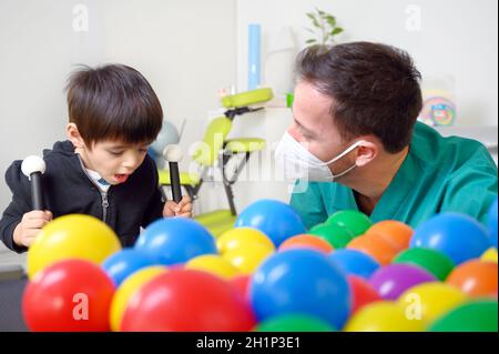 Physical therapist playing with children, with cerebral palsy. High quality photo Stock Photo