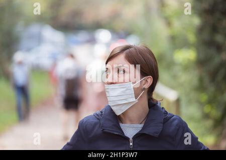 Young woman is wearing face mask wrong, nose uncovered Stock Photo