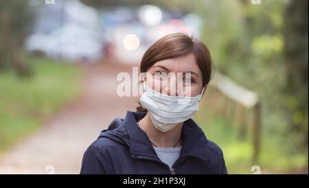 Young woman is wearing face mask wrong, nose uncovered Stock Photo