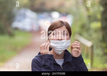 Young woman is wearing face mask wrong, nose uncovered Stock Photo