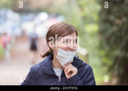 Young woman is wearing face mask wrong, nose uncovered Stock Photo