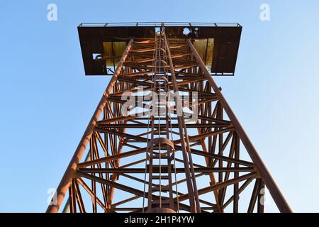 The old rusty water tower tilted. An old rustic communal communication. Stock Photo