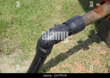 The pipe from the water tower. Steel or plastic pipe, valve and knee on the tube. Stock Photo