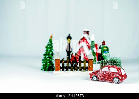 Right side of the picture red car with christmas tree on the roof going home. Stock Photo