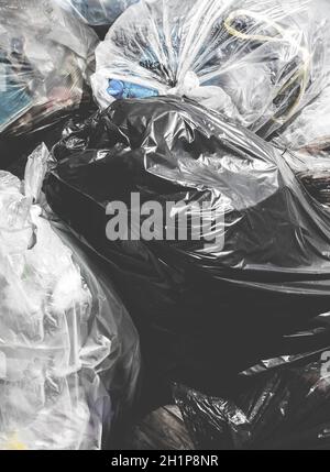 Garbage bags. Piles of garbage in plastic bin bags. Landfill. Close-up for background. Retro style photo. Stock Photo