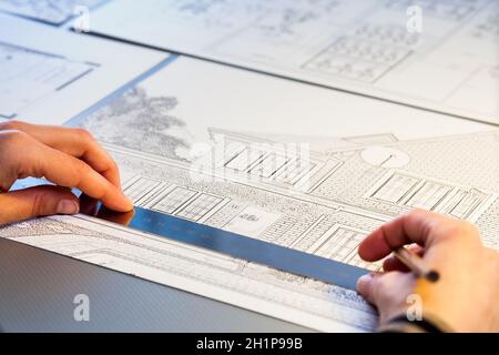 Macro close up of Hands measuring detail on house plan. Stock Photo
