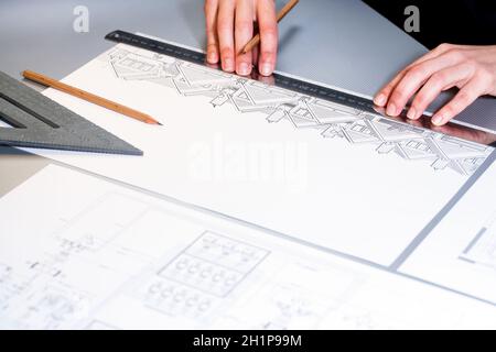 Macro close up of architects hands working on design document. Stock Photo