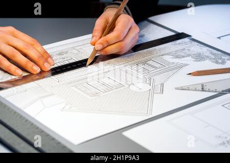 Macro close up of quantity surveyor working on architectural layout. Stock Photo