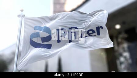 Rome, Italy, January 26, 2021: White flag with the new Pfizer logo waving in the wind. Pfizer is an American pharmaceutical company that has produced Stock Photo