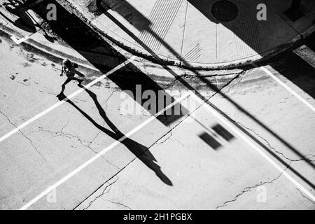 Pedestrians and their shadows viewed from above on Sherbrooke Street in Montreal's Golden Square Mile area at the foot of Mont Royal.