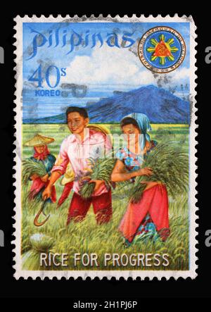 Stamp issued in the Philippines shows President and Mrs. Marcos harvesting miracle rice, Series: Rice for Progress, circa 1969 Stock Photo