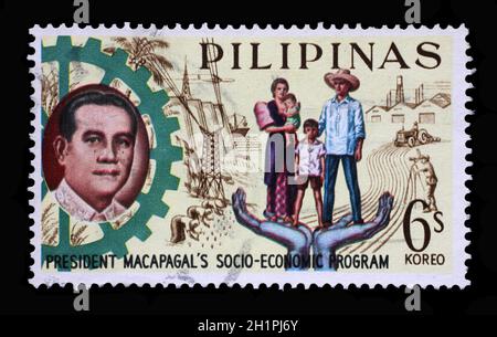 Stamp printed in Philippines shows President Macapagal and Filipino family, Series 5-year Socioeconomic Program, circa 1963. Stock Photo