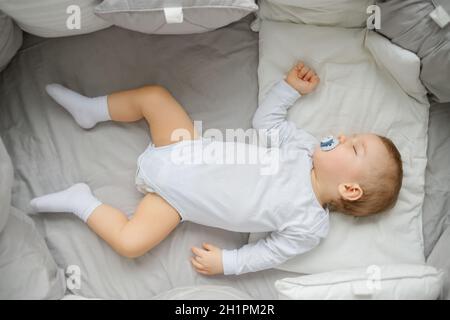 Little baby sleeping in crib , top view Stock Photo
