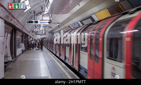 LONDON, UK - CIRCA SEPTEMBER 2019: passengers boarding and alighting London Underground (aka Tube) subway train Stock Photo