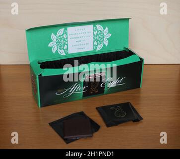 After Eight mint chocolate thins chocolates with alarm clock showing time  as just past eight o'clock Stock Photo - Alamy