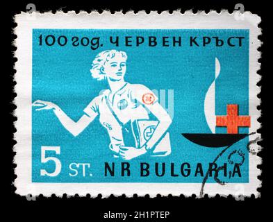 Stamp printed in Bulgaria devoted to 100 anniversary of the Red Cross shows a woman doctor, circa 1963 Stock Photo