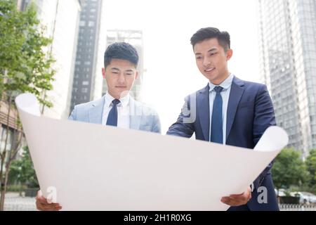 Architects viewing architectural drawings Stock Photo