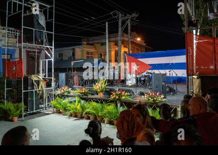 Santa Clara, Cuba - January 27 2019: Stage with audio equipment decorated with flower and a Cuban flag in the background. People waiting for the perfo Stock Photo