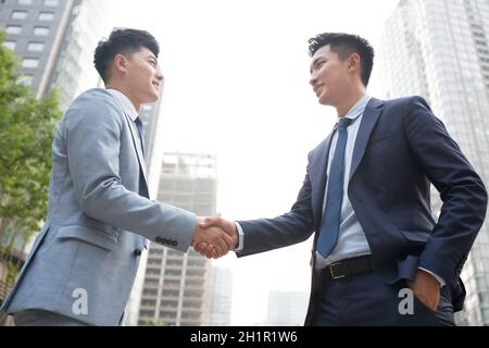 Confident businessmen shaking hands Stock Photo