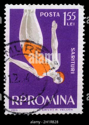 Stamp printed in the Romania shows Woman Diver, Jumping into Water from Platform, circa 1963 Stock Photo