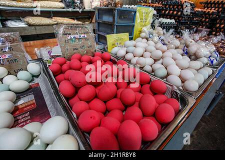 Khao Lak, Thailand - February 22, 2016:  Pink preserved century eggs (cured in mix of lime, clay, salt, and rice - they're black inside) on local mark Stock Photo