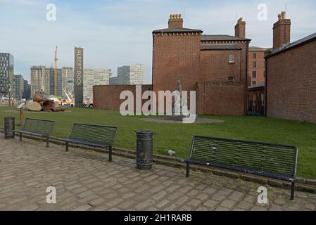 Liverpool, United Kingdom, 2nd February, 2020: Three empty benches in front of the pier masters house at the Royal Albert Dock waterfront. Stock Photo