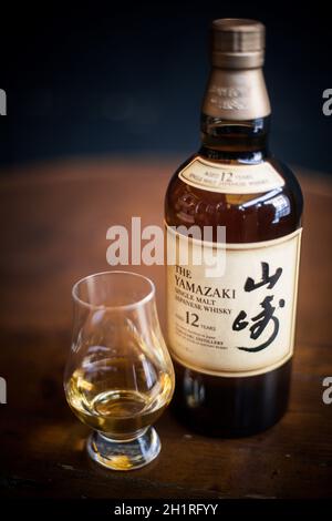 Bucharest, Romania - February 25, 2021: Illustrative editorial image of a Yamazaki single malt Japanese whisky bottle and a Glencairn whisky glass in Stock Photo
