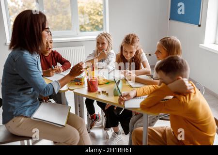 Female teacher during the lesson with pupils in the classroom Stock Photo