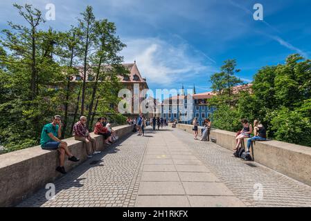 Bamberg, Germany - May 22, 2016: People seating and passing by bridge in downtown of Bamberg, Upper Franconia, Bavaria, Germany. Bamberg is under UNES Stock Photo