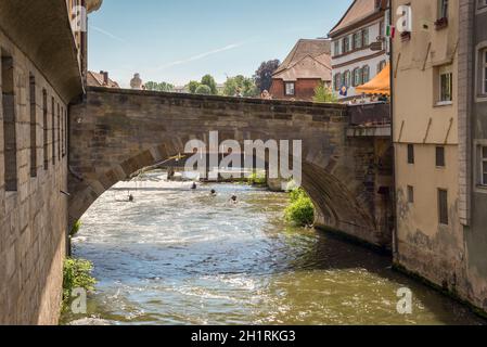 Bamberg, Germany - May 22, 2016: Old bridge over the Regnitz river in downtown of Bamberg, Upper Franconia, Bavaria, Germany. Bamberg is under UNESCO Stock Photo