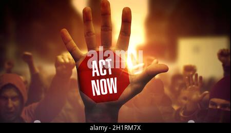 Crowd of Multi-ethnic People on Demonstration. Act Now Written on Raised Palm. Act Now - Up Close of Raised Palm on Loud Demonstration. Public Protest Stock Photo