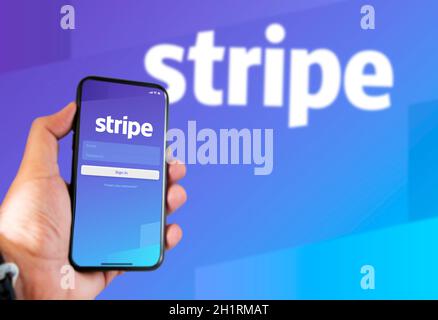 San Francisco, CA, USA, March 15, 2021: Stripe's application login page on the screen of a hand held smartphone. Background with blurry Stripe logo. S Stock Photo