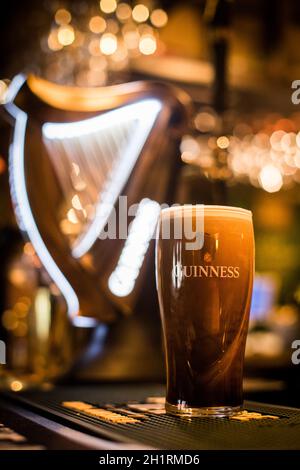 Bucharest, Romania - February 25, 2021: Illustrative editorial close up image of a pint of Guinness beer on a pub's counter. Stock Photo