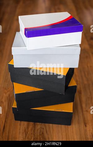 A small stack of cardboard boxes on the floor. Preparation for moving or delivery of goods by mail. Stock Photo
