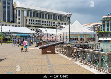 Port Louis, Mauritius - December 25, 2015: Caudon Waterfront at the harbour in Port Louis Mauritius with historical cannon in Port Louis, Mauritius. Stock Photo