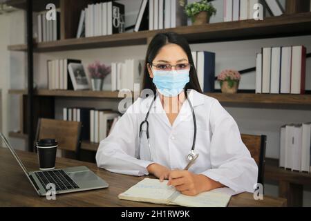 Doctor using laptop in office. Stock Photo