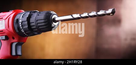 Composition with a cordless drill also working as a screw gun Stock Photo