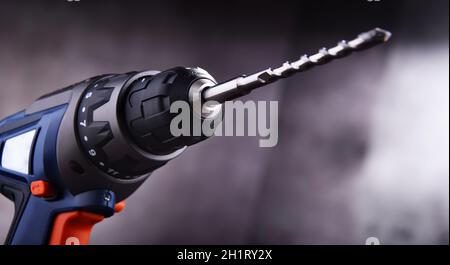 Composition with a cordless drill also working as a screw gun Stock Photo