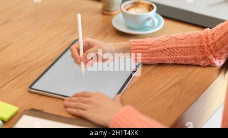 Close-up young female college student lecture her online class on modern digital tablet computer. tablet screen mockup. Stock Photo