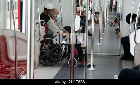 Senior Disabled person in wheelchair on traveling in train for transportation. Stock Photo