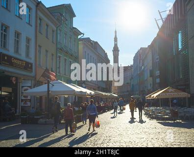 TALLINN, ESTONIA - JULY 14, 2019: People walking by sunny street at Old Town of Tallinn. Stock Photo