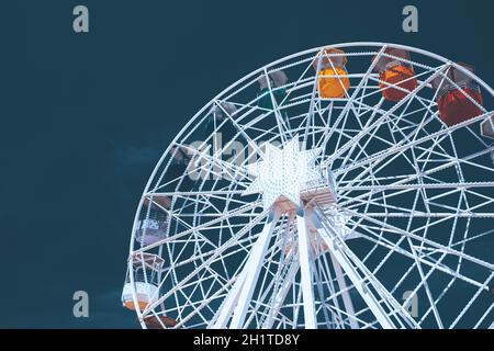 Colorful ferris wheel over blue sky - vintage color Stock Photo