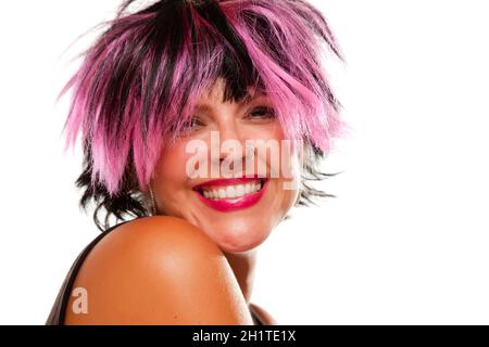 Pink And Black Haired Girl with Nose Ring Smiling Isolated on a White Background. Stock Photo