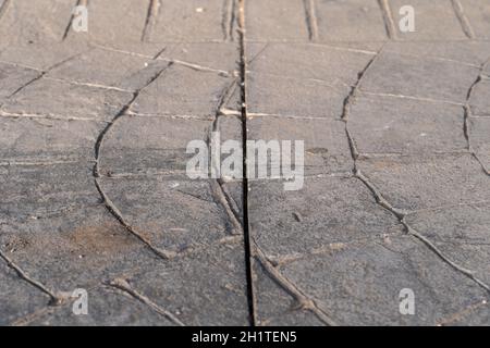 expansion joint Dilatation on surfaces of stamped concrete flooring pavement outdoor, appearance colors and textures of paving stone on cement Stock Photo