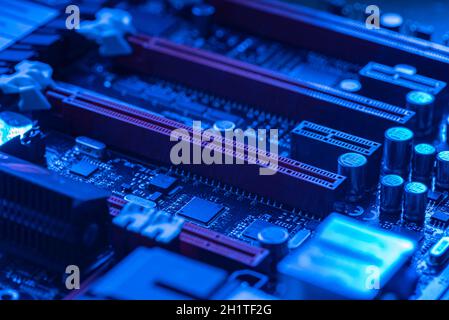 LOS ANGELES, USA 25 APRIL 2021: Pcie slot detail n a motherboard of a gaming pc in a blue light Stock Photo