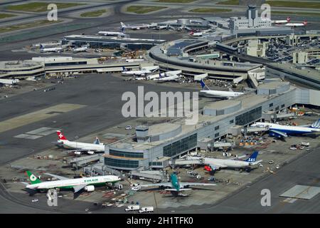 Planes and terminals at San Francisco International Airport, San Francisco, California, USA - aerial Stock Photo