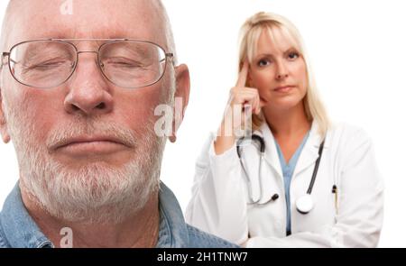 Concerned Senior Man and Female Doctor Behind with Selective Focus the Gentleman in front. Stock Photo